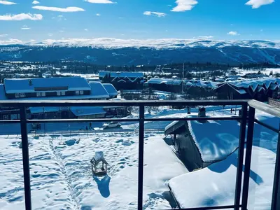 a view from the balcony of a snow covered mountain at Riddertunets toppleilighet in Beitostøl