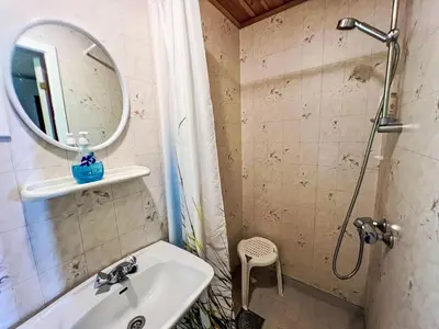 a bathroom with a sink and a mirror and a shower at Holiday Home Askelund by Interhome in Uggdal