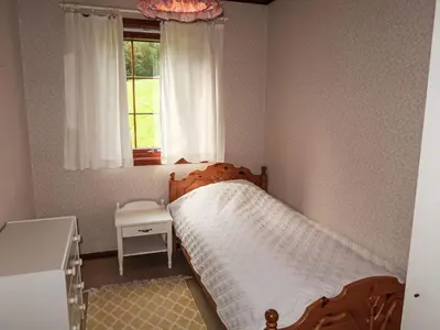 a small bedroom with a bed and a window at Holiday Home Askelund by Interhome in Uggdal