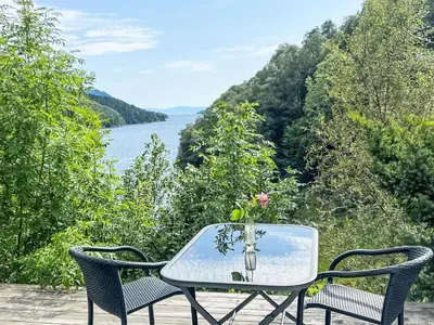a glass table with a vase on top at Holiday Home Askelund by Interhome in Uggdal