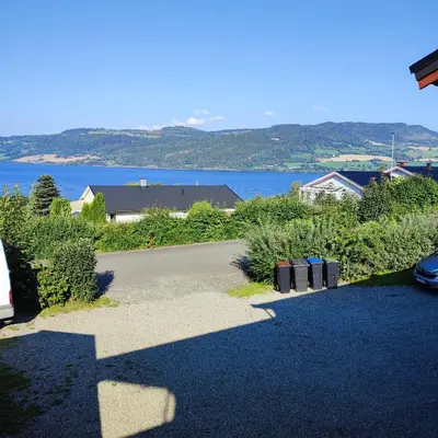 a driveway with a view of a body of water at Separate rooms in a large house,on the E6 road in Biri