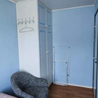 a room with a chair and a closet at Separate rooms in a large house,on the E6 road in Biri