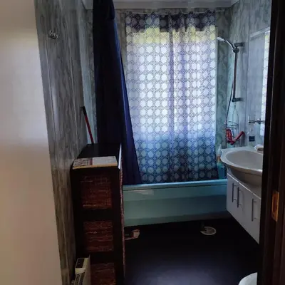 a bathroom with a sink and a shower curtain at Separate rooms in a large house,on the E6 road in Biri