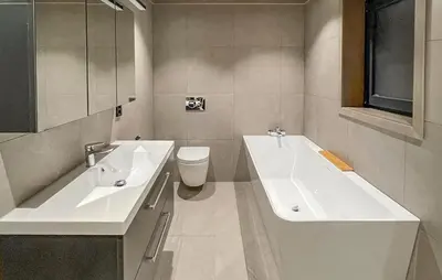 a bathroom with two sinks and a toilet at 5 Bedroom Stunning Home In Løten in Løten