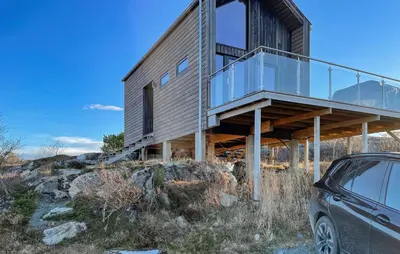 a house on a hill with a car parked in front at Nice Home In Lysøysundet With Wifi in Lysøysund