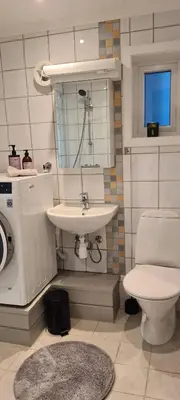 a bathroom with a sink and a toilet at Fjord view in centre with parking in Ålesund