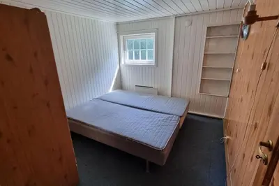 a small room with a bed and a window at House in Austevoll in Austevoll