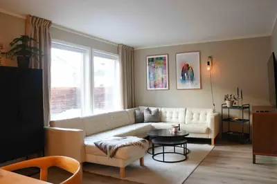 a living room with a white couch and a table at Entire house less than 2 km from Granåsen, WC 2025 in Trondheim