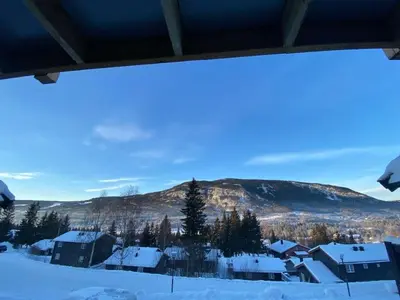 a view of a snow covered village with a mountain at Ruud Tun in Hafjell