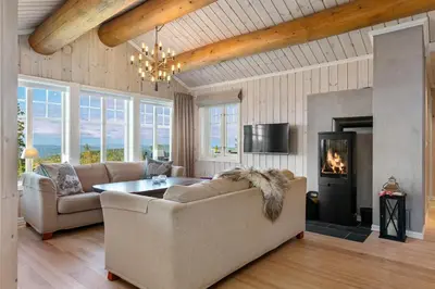 a living room with a couch and a fireplace at HYTTEEVENTYR I VALDRES MED JACUZZI, 5 soverom, alpinbakke og skiløyper like ved! in Aurdal