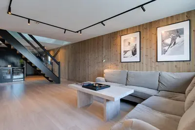 a living room with a couch and a table at Stølstunets toppetasje in Beitostøl