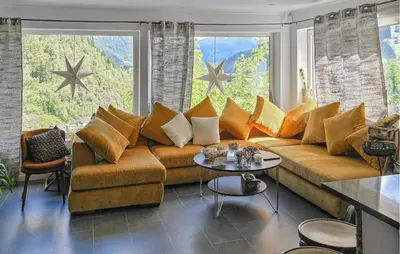 a living room with a large couch with pillows at Gorgeous Home In Førde in Førde