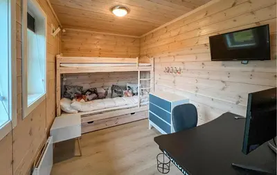 a small room with a bed in a wooden wall at Gorgeous Home In Svingvoll With Wifi in Svingvoll