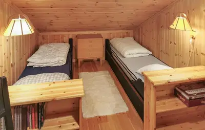 two beds in a cabin with wooden walls at Stunning Home In Rjukan With Sauna in Rjukan