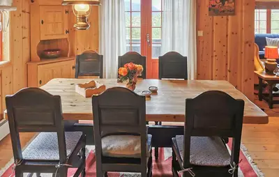 a dining room with a wooden table and chairs at Stunning Home In Rjukan With Sauna in Rjukan