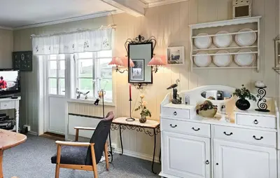 a room with a white dresser and a table and a mirror at 3 Bedroom Amazing Home In Sula in Sula
