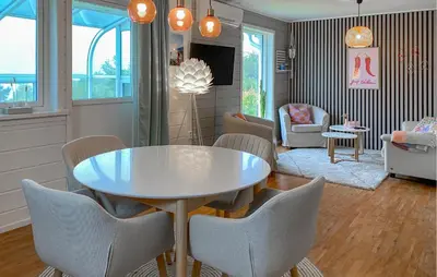 a dining room with a white table and chairs at Gorgeous Home In Sørbøvågen With Wifi in Saltbu