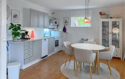 a kitchen with a table and chairs in a room at Gorgeous Home In Sørbøvågen With Wifi in Saltbu