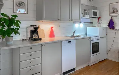 a kitchen with white cabinets and white appliances at Gorgeous Home In Sørbøvågen With Wifi in Saltbu
