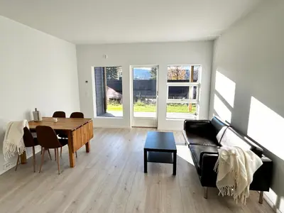 a living room with a couch and a table at Modern apartment with two bedrooms in Moelv