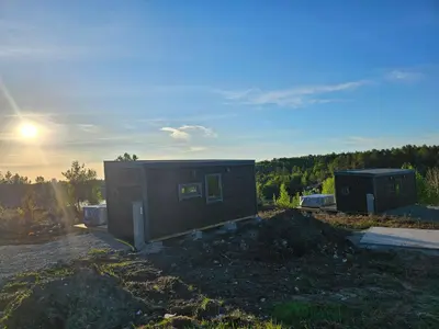 a tiny house sitting on top of a pile of dirt at WayCamp Tustna in Leira