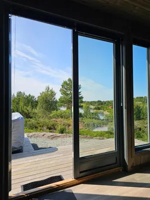 a screened in porch with sliding glass doors at WayCamp Tustna in Leira