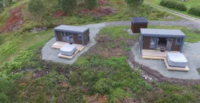 an overhead view of three tiny homes on a hill at WayCamp Tustna in Leira
