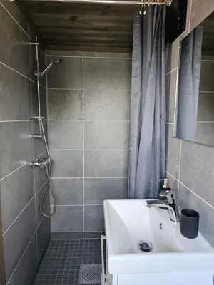 a bathroom with a sink and a shower at WayCamp Tustna in Leira