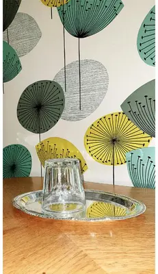 a glass jar on a plate on a table with umbrellas at Sanden pensjonat in Lærdalsøyri
