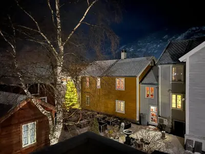 a group of houses and a tree at night at Sanden pensjonat in Lærdalsøyri