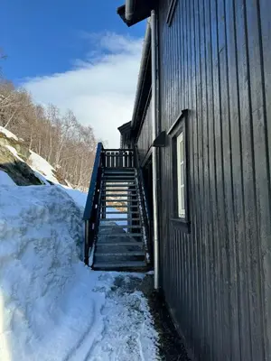 a staircase leading up to a building in the snow at Cozy Apartment - Great View! in Håra