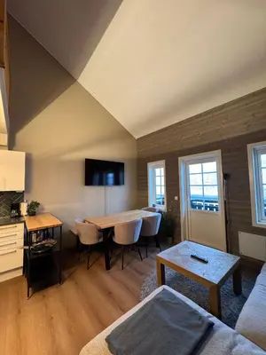 a living room with a table and a couch at Cozy Apartment - Great View! in Håra