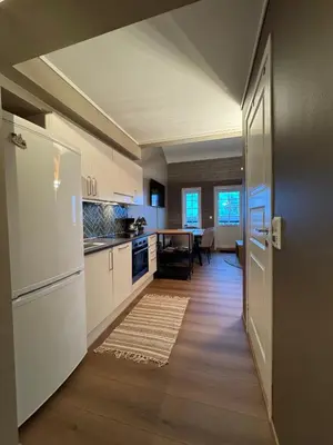 a kitchen with a white refrigerator and a table at Cozy Apartment - Great View! in Håra