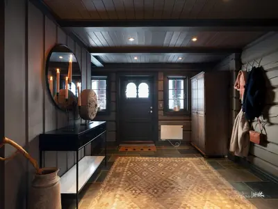 a hallway with a black door and a mirror at Modern cabin in Vestlia - EV Type 2 - Sauna - WiFi - Games in Geilo