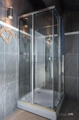 a glass shower stall in a bathroom with a wall at Modern cabin in Vestlia - EV Type 2 - Sauna - WiFi - Games in Geilo