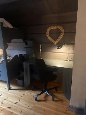 a desk with a chair and a lamp in a room at Modern cabin in Vestlia - EV Type 2 - Sauna - WiFi - Games in Geilo