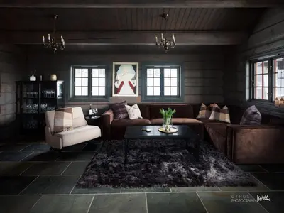a living room with a couch and a table at Modern cabin in Vestlia - EV Type 2 - Sauna - WiFi - Games in Geilo