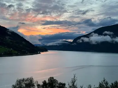 a view of a large body of water with mountains at Olden Apartment with Panorama view in Olden
