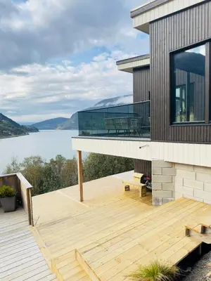 a house with a deck with a view of a lake at Olden Apartment with Panorama view in Olden