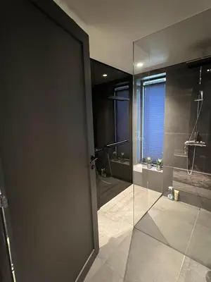 a bathroom with a shower and a glass door at Spacious, exclusive and modern cabin in Geilo in Geilo