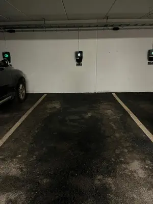 a garage with a car parked next to a white wall at Exclusive Ski In-Out apartment in Hemsedal next to Fyri Resort in Hemsedal