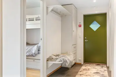 a bedroom with a green door and a closet at Nydelig utsikt, ski in out, 3 soverom in Aurdal