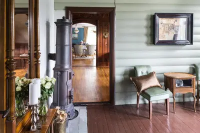 a hallway of a home with a chair and a table at Jervell 1 Bnb in Ålesund