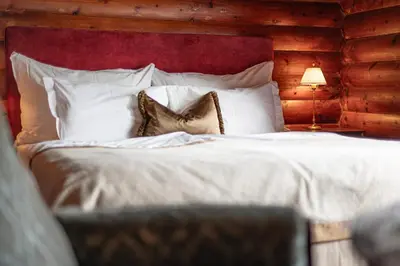 a bed with white pillows and a red head board at Jervell 1 Bnb in Ålesund