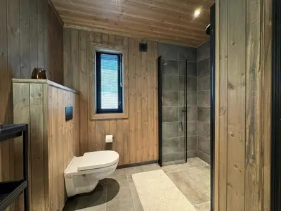a bathroom with a toilet and a shower at Roaldsida Retreat in Stranda