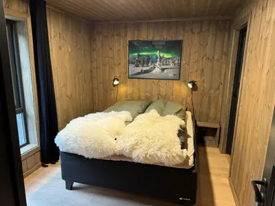 a bedroom with a bed covered in white fur at Roaldsida Retreat in Stranda