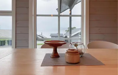 a table with a glass bowl and a glass jar on a table at 4 Bedroom Nice Home In Hildre in Hildre