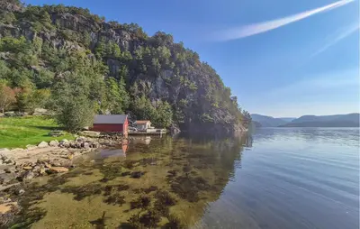 a house on the shore of a body of water at 5 Bedroom Cozy Home In Hebnes in Hebnes