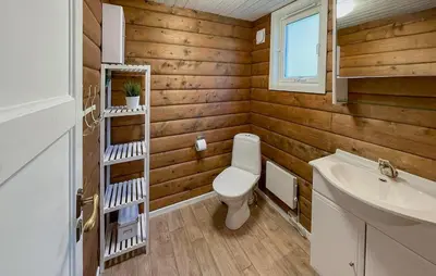 a bathroom with a toilet and a sink at 5 Bedroom Cozy Home In Hebnes in Hebnes