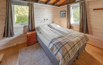 a bedroom with a bed in a tiny house at 5 Bedroom Cozy Home In Hebnes in Hebnes